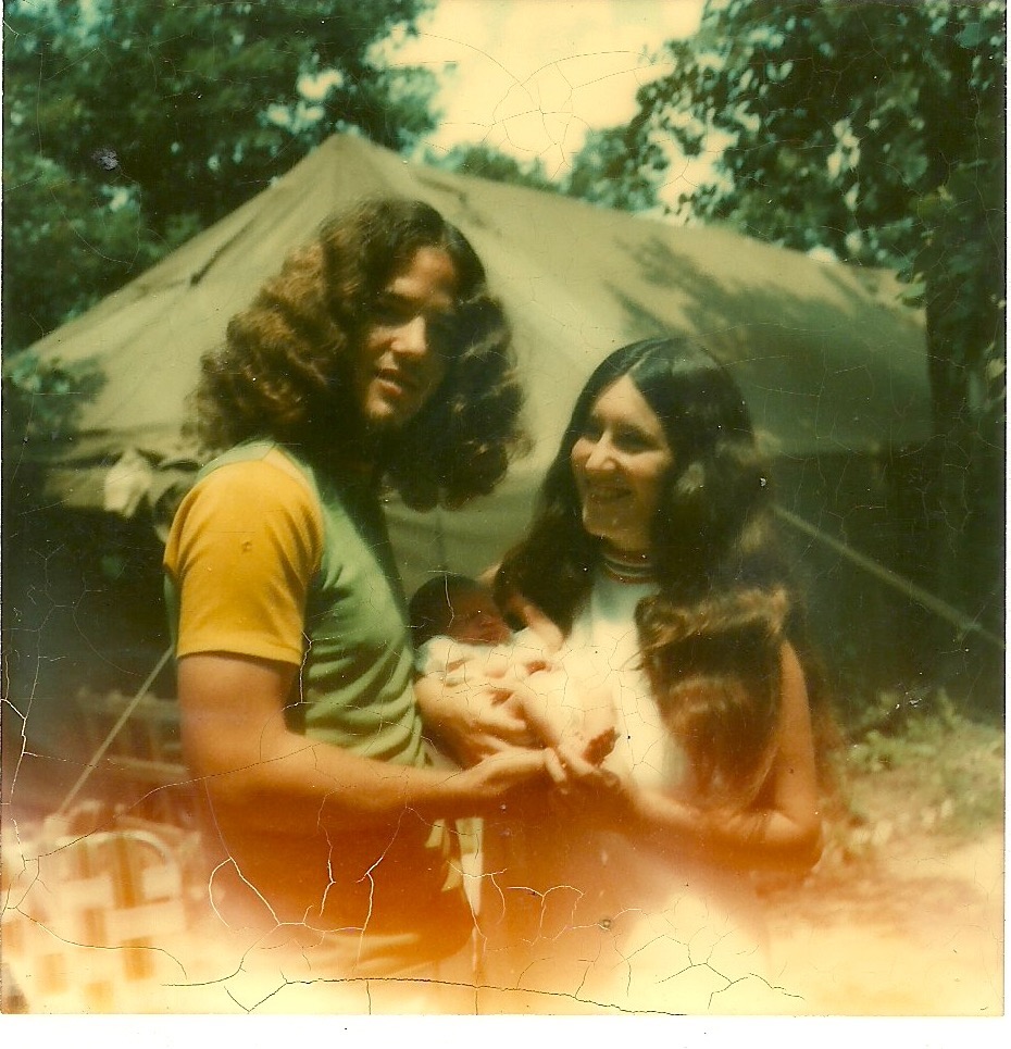 In the woods with infant - and "house" in background